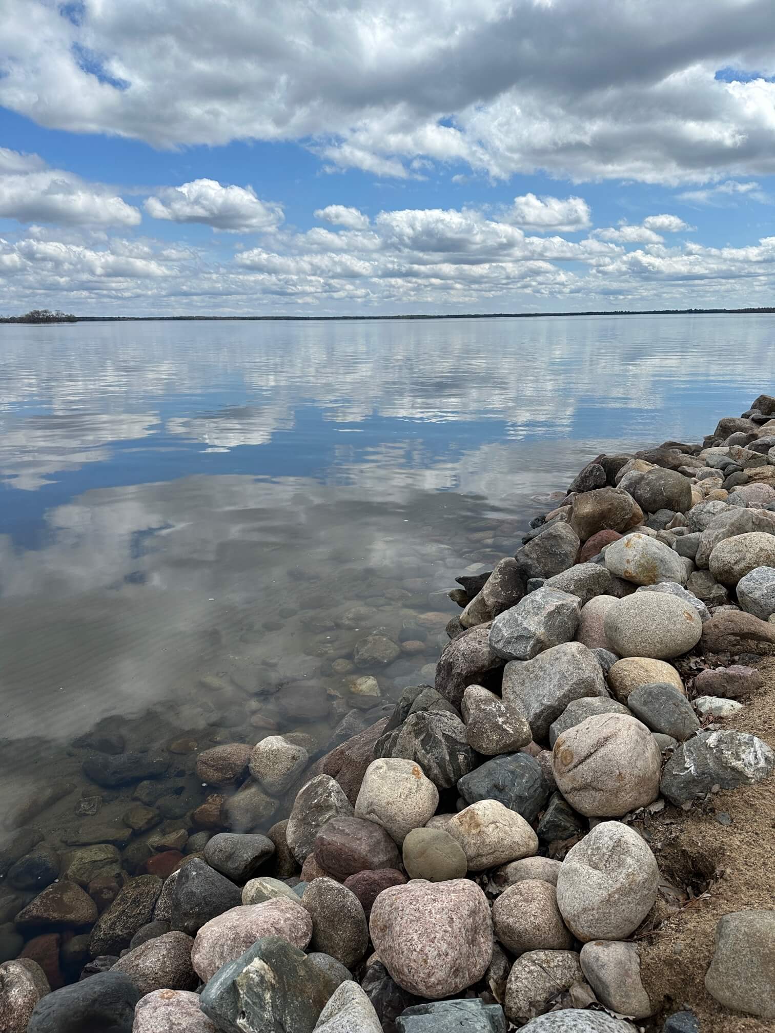 photo of a rocky shore of Pelican Lake in Breezy Point